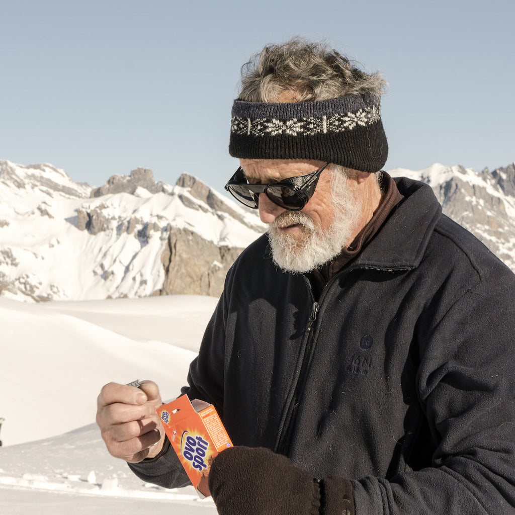 Roland Cachot with the Moiry Black Glacier sunglasses eating Ovo Sport during ski touring