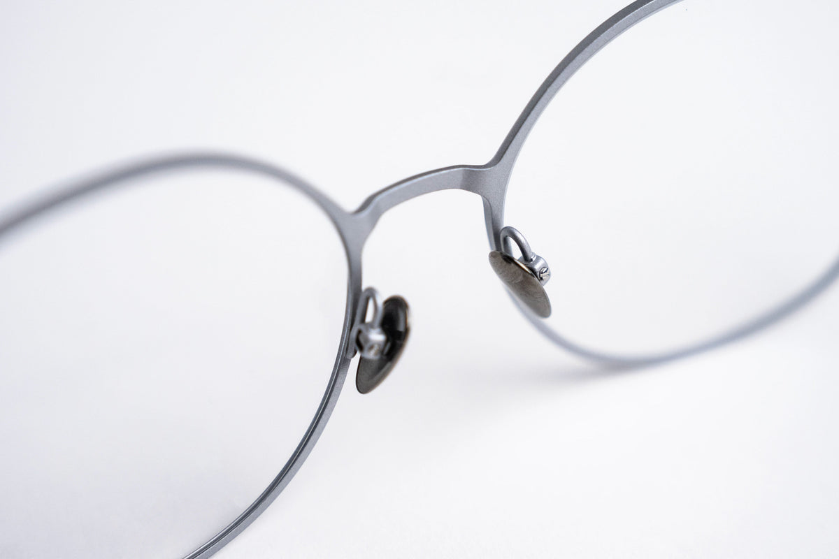Close-up of a pair of titanium eyeglasses on a white background