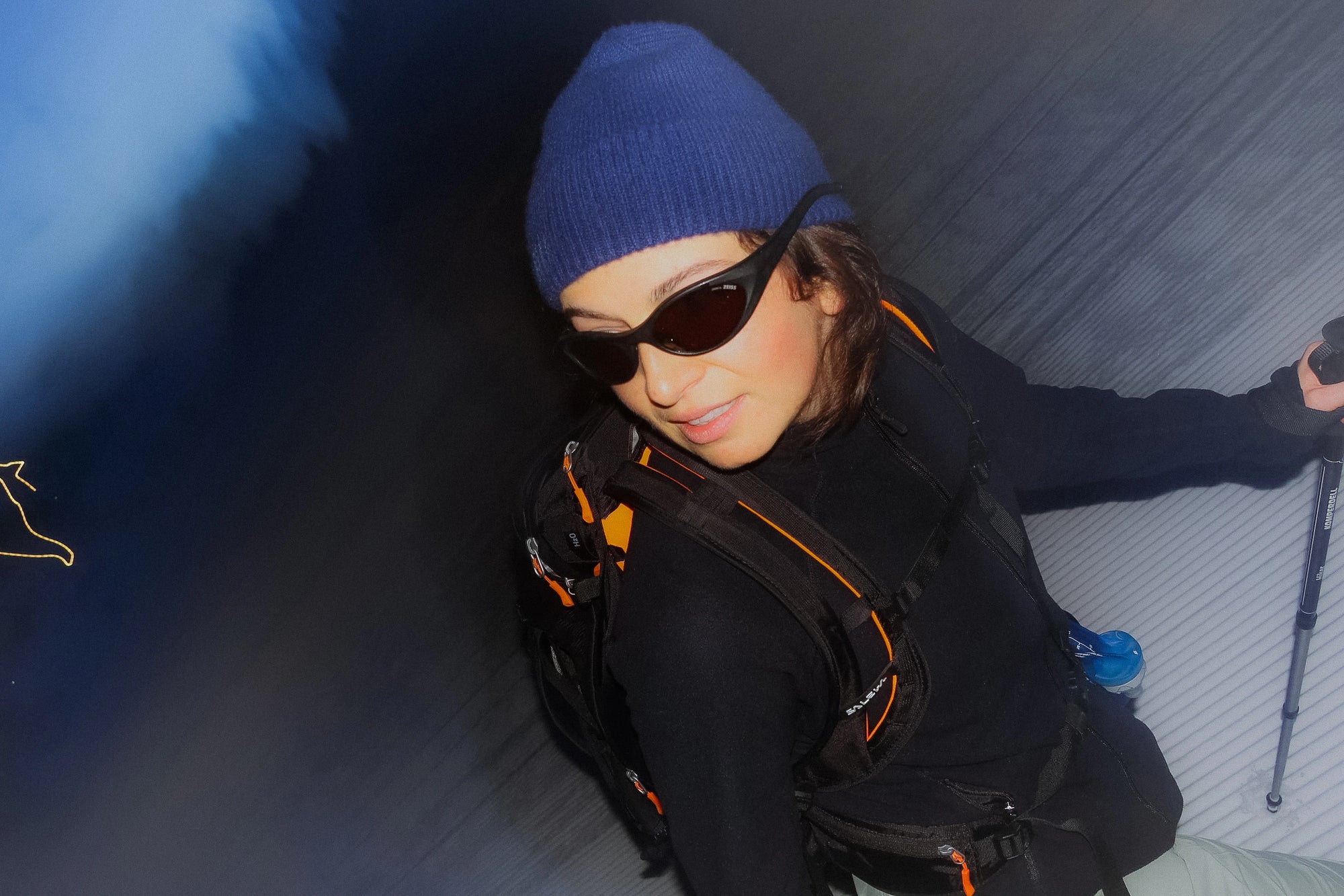 A woman wearing a Vorab black sunglasses in alpine mountains at night.